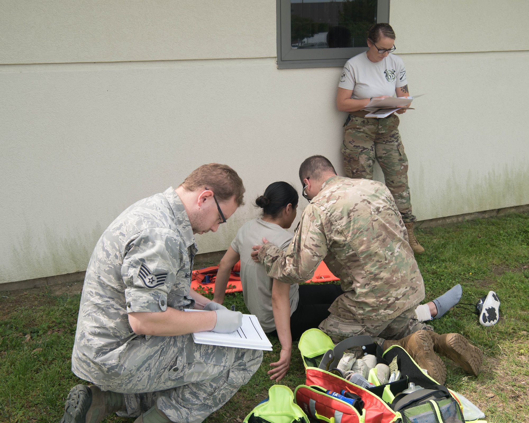 A member of the 633d Medical Group evaluates participants in the emergency medical technician course during a hands-on portion of their EMT recertification training on Joint Base Langley-Eustis, Virginia, May 17, 2019. Members who were trying to get recertified had to go through a week-long program which incorporated both classroom lecture, hands-on training and a written test. (U.S. Air Force photo by Airman 1st Class Marcus M. Bullock)