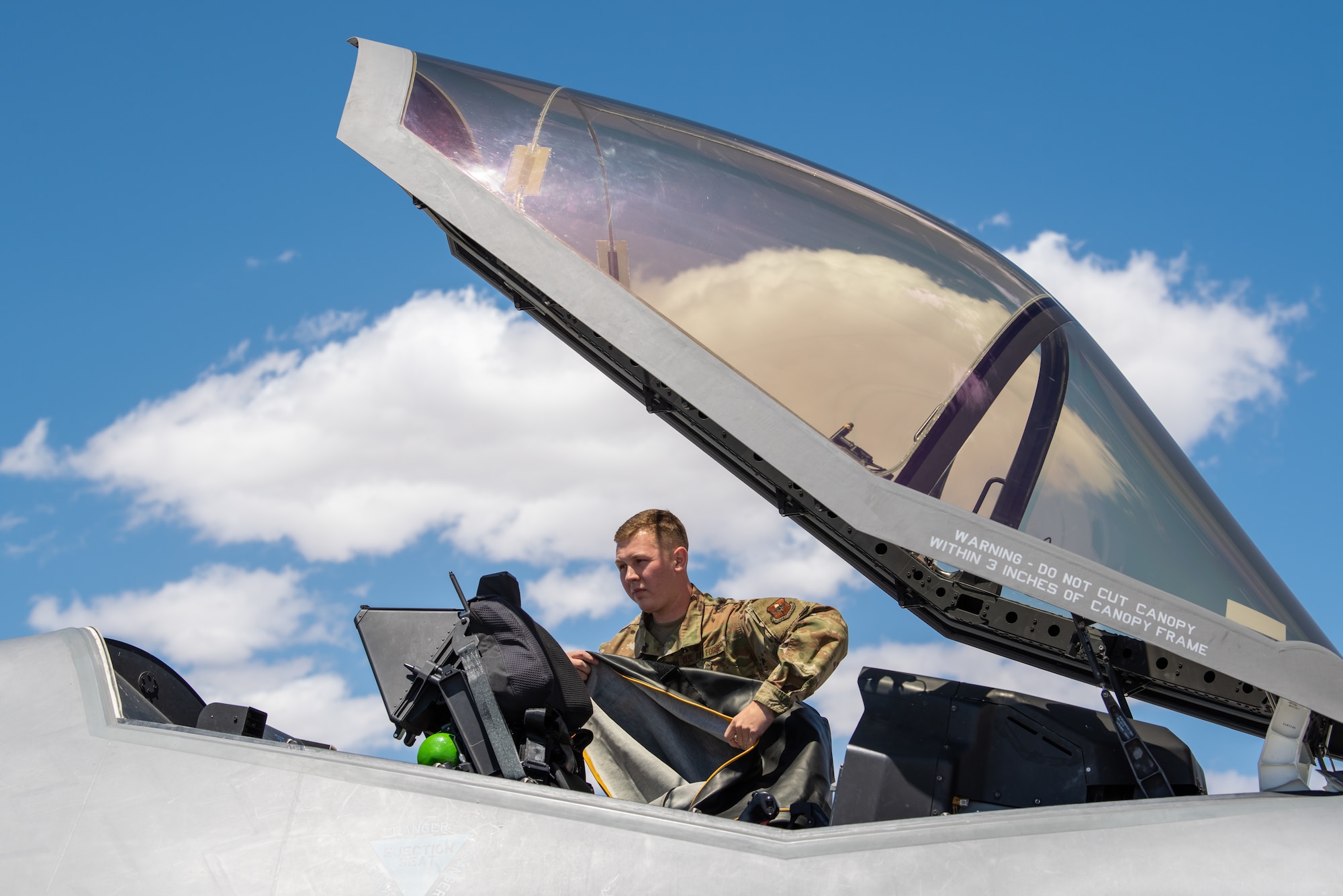 Senior Airman John Botner, 61st Aircraft Maintenance Unit assistant dedicated crew chief, secures an F-35A Lightning II, May 21, 2019 at Phoenix-Mesa Gateway Airport.