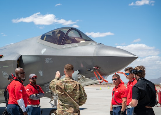 Senior Airman John Botner, 61st Aircraft Maintenance Unit assistant dedicated crew chief, instructs employees of the Phoenix-Mesa Gateway Airport how to recover an F-35A Lightning II, May 21, 2019, in Mesa, Ariz.