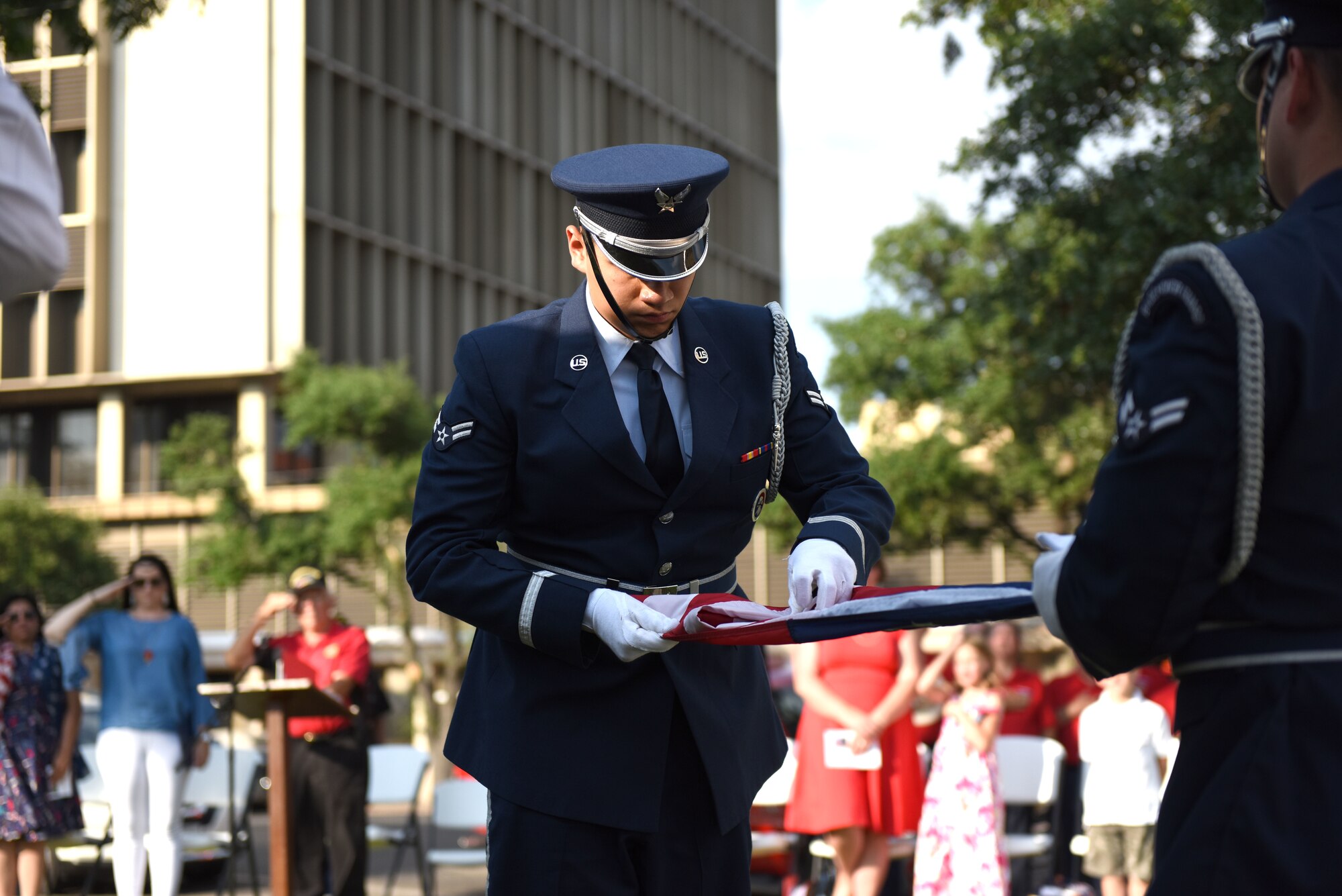 U.S. Air Force Airman 1st Class Issak Guerrero, Goodfellow Air Force Base Honor Guard member, folds the flag for a special presentation ceremony during the Memorial Day Commemoration at the Tom Green County Courthouse in San Angelo, Texas, May 27, 2019. The flag was presented to Kathy Fiscus in honor of her husband’s service. (U.S. Air Force photo by Senior Airman Seraiah Hines/Released)