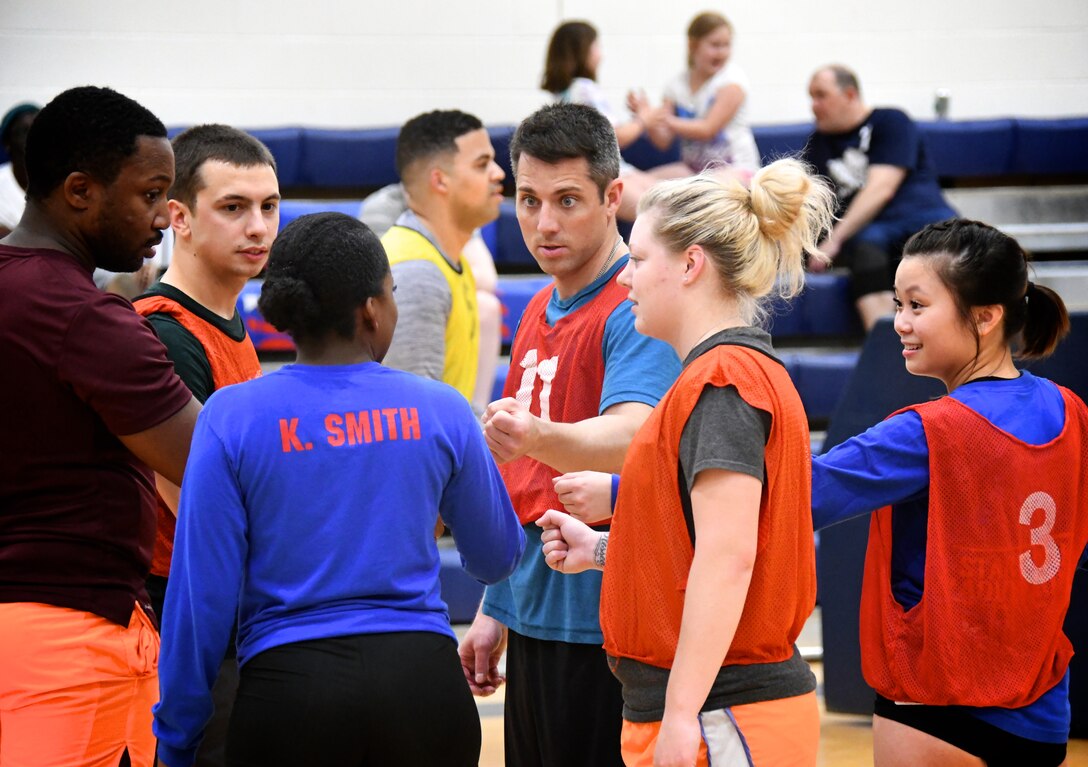 The commander of the 932nd Airlift Wing Logistics Flight, Capt. James Harbison, speaks about teamwork to the 932nd AW team during intense league intramural competition May 16, 2019, at Scott Air Force Base, Ill.  At right Senior Airman Katie Baskerville reacts to the motivational message.
"My thoughts about this year’s volleyball team is this: It doesn’t matter about the wins or the losses. What matters is that we all have fun, and as cliché as that may sound, it’s why we play and continue to do so," said Baskerville.
