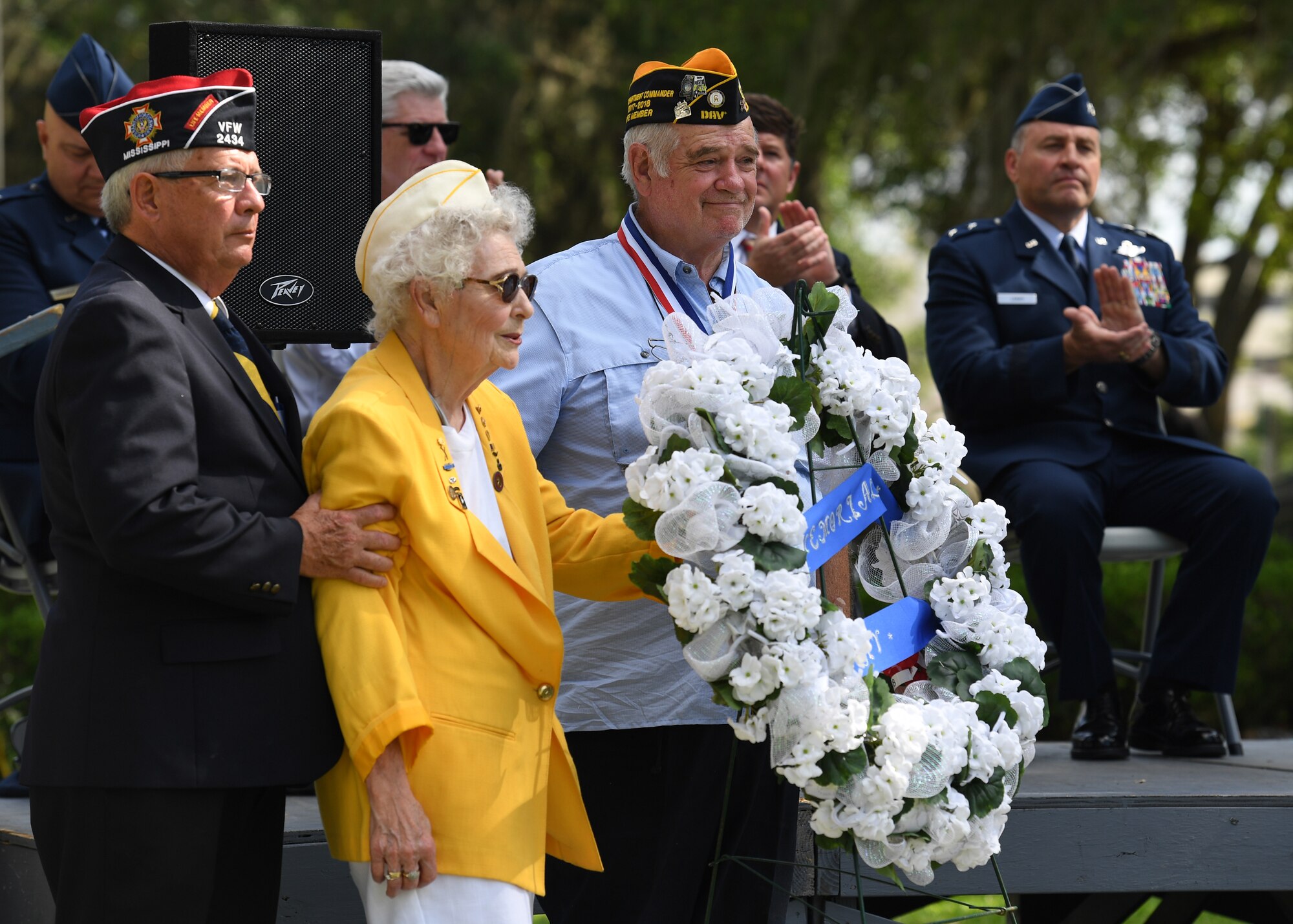 Emily Crower, spouse of retired U.S. Army Maj. Albert Crower, presents a wreath on behalf of the Gold Star Wives organization during the Biloxi National Cemetery Memorial Day Ceremony in Biloxi, Mississippi, May 27, 2019. The ceremony honored those who have made the ultimate sacrifice while serving in the armed forces. Biloxi National Cemetery is the final resting place of more than 23,000 veterans and their family members. Eight hundred burials take place there every year for men and women who served in wars years ago and for those defending America today. (U.S. Air Force photo by Kemberly Groue)