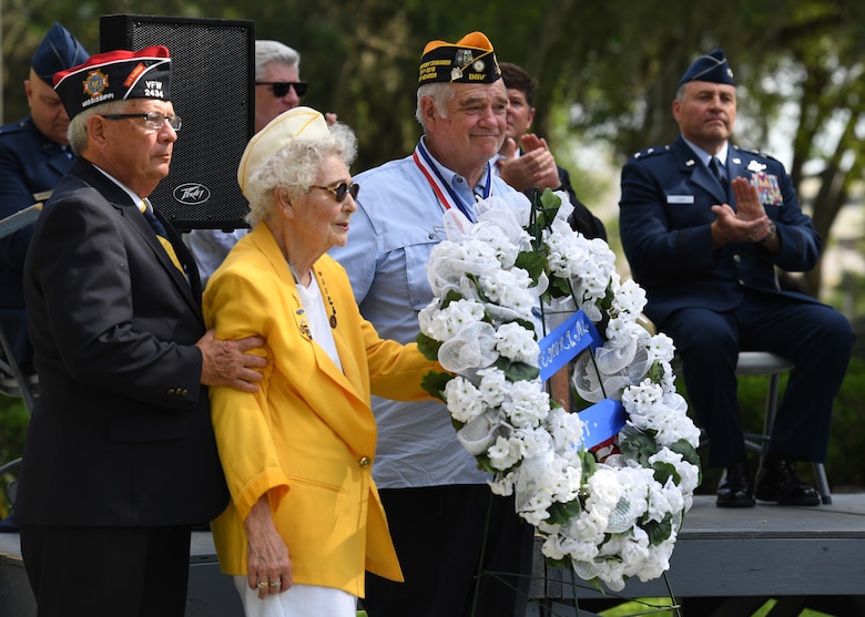 Emily Crower, spouse of retired U.S. Army Maj. Albert Crower, presents a wreath on behalf of the Gold Star Wives organization during the Biloxi National Cemetery Memorial Day Ceremony in Biloxi, Mississippi, May 27, 2019. The ceremony honored those who have made the ultimate sacrifice while serving in the armed forces. Biloxi National Cemetery is the final resting place of more than 23,000 veterans and their family members. Eight hundred burials take place there every year for men and women who served in wars years ago and for those defending America today. (U.S. Air Force photo by Kemberly Groue)