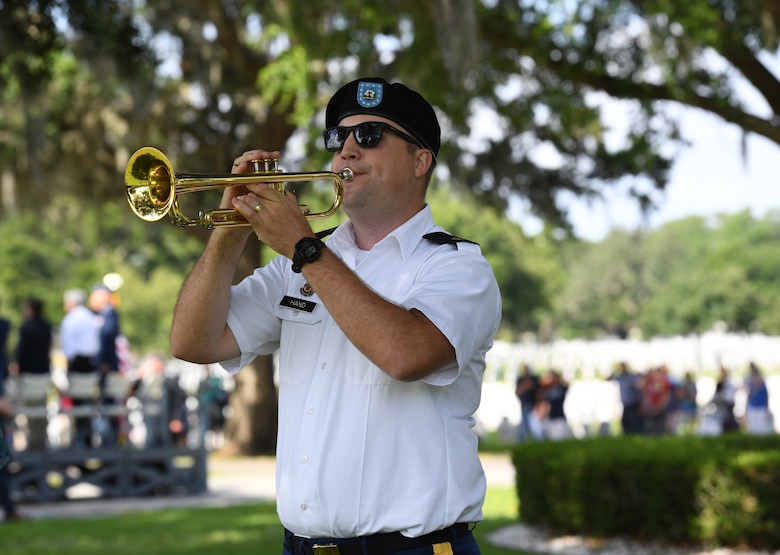 U.S. Army Sgt. Patrick Hand, 41st Army Band, Jackson, Mississippi, plays Taps during the Biloxi National Cemetery Memorial Day Ceremony in Biloxi, Mississippi, May 27, 2019. The ceremony honored those who have made the ultimate sacrifice while serving in the armed forces. Biloxi National Cemetery is the final resting place of more than 23,000 veterans and their family members. Eight hundred burials take place there every year for men and women who served in wars years ago and for those defending America today. (U.S. Air Force photo by Kemberly Groue)