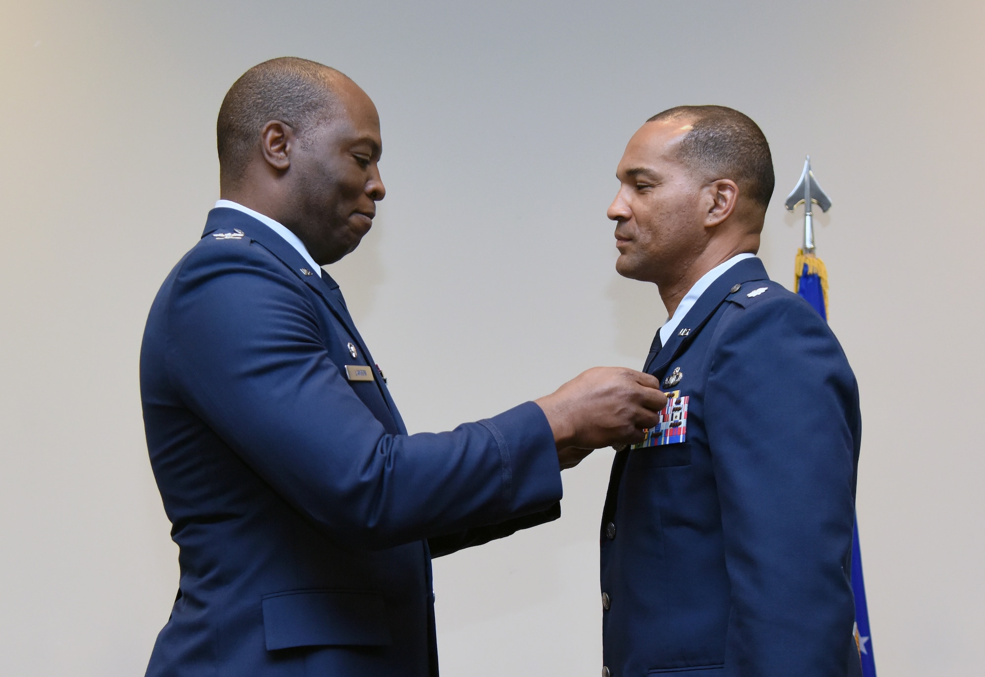 U.S. Air Force Col. Leo Lawson, Jr., 81st Training Group commander, presents the Meritorious Service medal to Lt. Col. Billy Wilson, Jr., outgoing 334th Training Squadron commander, during the 334th TRS change of command ceremony in the Roberts Consolidated Aircraft Maintenance Facility at Keesler Air Force Base, Mississippi, May 23, 2019. Wilson passed on command to Lt. Col. Harry James during the ceremony. (U.S. Air Force photo by Kemberly Groue)
