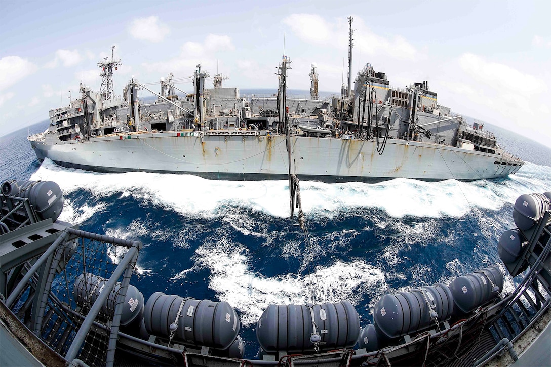 Two ships complete a replenishment at sea.