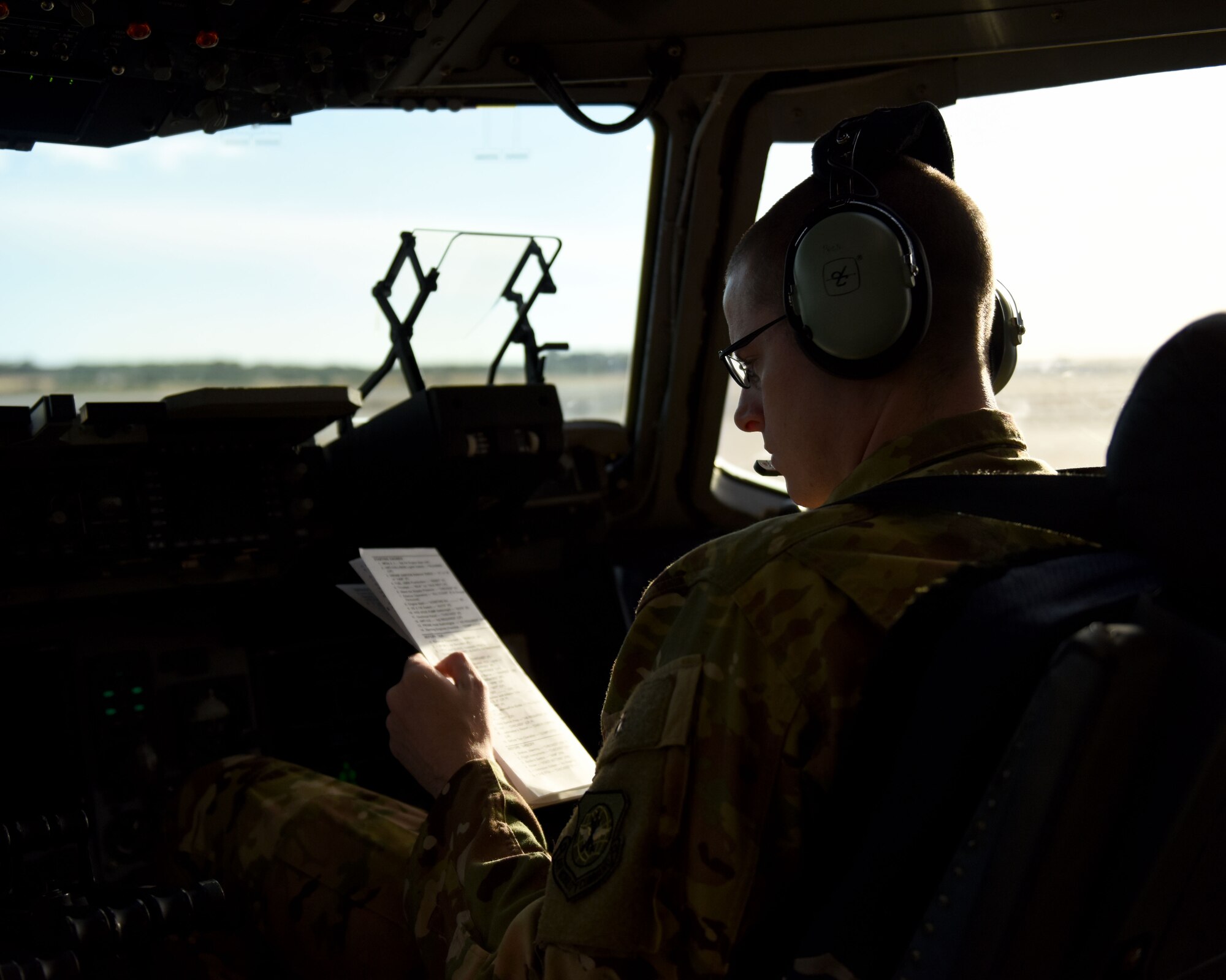 U.S. Air Force Capt. Justin Poole, 21st Airlift Squadron pilot, runs a pre-flight checklist on a C-17 Globemaster III May 19, 2019, at Rota Naval Air Station, Spain. The C-17 is capable of rapid strategic delivery of troops and cargo anywhere in the world. (U.S. Air Force photo by 2nd Lt. R. Michael Longoria)