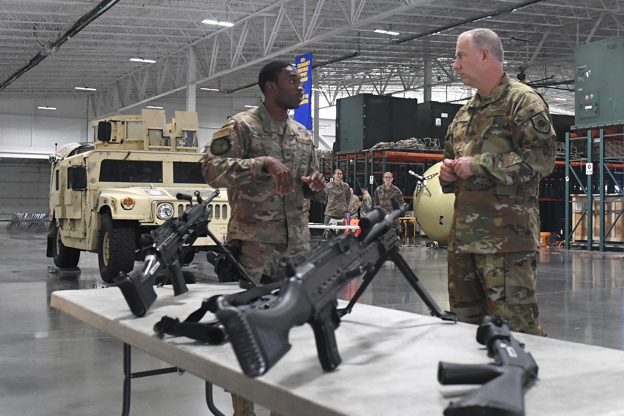 Maj. Gen. John Gordy, U.S. Expeditionary Center commander, right, receives a briefing from Staff Sgt. Malcolm Mullen, 921st  Contingency Response Squadron security forces, during his visit to Travis A­ir Force Base, California, May 21, 2019. During the visit, Airmen briefed the capabilities of their unit and showcased innovation projects. The 621st CRW is a unique bicoastal unit highly-specialized in training and rapidly deploying personnel to quickly open airfields and establish, expand, sustain and coordinate air mobility operations. (U.S. Air Force photo by Tech. Sgt. Liliana Moreno)