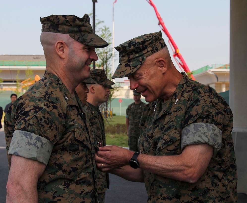 CAMP HUMPHREYS, Republic of Korea – Maj. Gen. Patrick J. Hermesmann, commander of U.S. Marine Corps Forces Korea, awards Lt. Col. Joseph Katz, G4 assistant chief of staff, the Meritorious Service Medal here, 29 May. Katz received the Meritorious Service Medal for his contributions to the unit in capabilities and readiness within the G4 section. (Official U.S. Marine Corps photos by Sgt. Nathaniel Hanscom/Released)