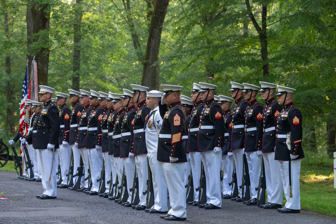U.S. Marines and Sailor from 3rd Battalion, 5th Marine Regiment, stand at attention during a private wreath-laying ceremony at the Iron Mike Statue near Belleau, France, May 26, 2019