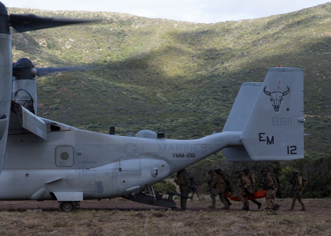 U.S. Marines with Special Purpose Marine Air-Ground Task Force-Crisis Response-Africa 19.2, Marine Forces Europe and Africa, and members of the Italian military load a simulated casualty onto a U.S. Marine Corps MV-22B Osprey during a joint tactical recovery of aircraft and personnel rehearsal during exercise Joint Stars 2019 in Capo Teulada, Sardinia, Italy, May 27, 2019.