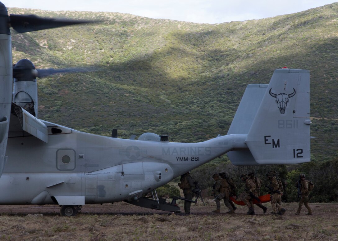 U.S. Marines with Special Purpose Marine Air-Ground Task Force-Crisis Response-Africa 19.2, Marine Forces Europe and Africa, and members of the Italian military load a simulated casualty onto a U.S. Marine Corps MV-22B Osprey during a joint tactical recovery of aircraft and personnel rehearsal during exercise Joint Stars 2019 in Capo Teulada, Sardinia, Italy, May 27, 2019. Joint Stars 2019 is a bilateral training exercise between the Italian Armed Forces and U.S. Marines. SPMAGTF-CR-AF is deployed to conduct crisis-response and theater-security operations in Africa and promote regional stability by conducting military-to-military training exercises throughout Europe and Africa. (U.S. Marine Corps photo by Staff Sgt. Mark E. Morrow Jr.)