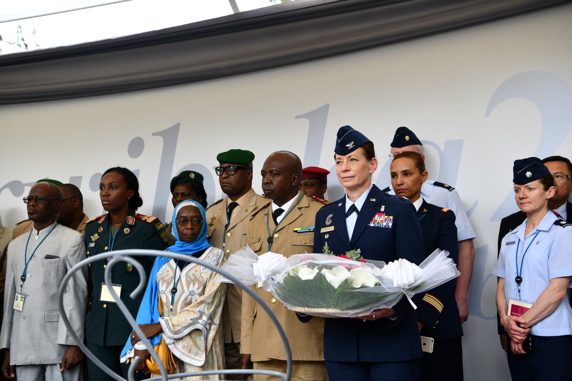 U.S. Air Force Col. Krystal Murphy, Deputy Command Surgeon for U.S. Africa Command, prepares to place a bouquet of flowers on a memorial during a visit to the Kigali Genocide Memorial in Kigali, Rwanda on May 22, 2019. Participants who attended the African Partner Outbreak Response Alliance (APORA) conference got an opportunity to visit the memorial for an afternoon. During APORA, military and civilian leaders worked together to align best practices and improve response capabilities for potential outbreaks of contagious diseases. The training bolstered relationships with current partners and mobilize new partners to strengthen pandemic prevention programs. (U.S. Air Force photo by Master Sgt. Andy M. Kin)
