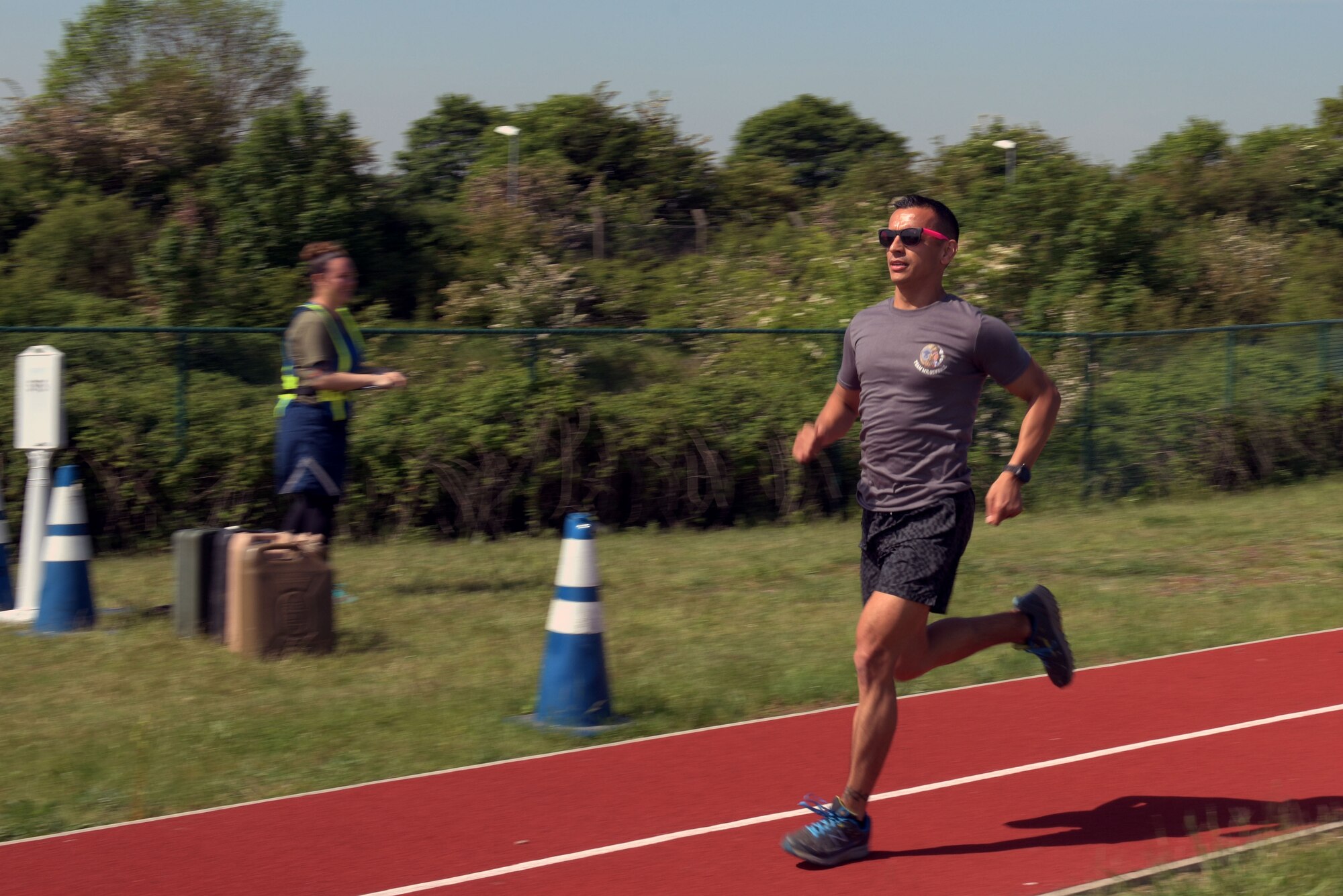 U.S. Air Force Chief Master Sgt. Cesar Flores, 100th Operations Group superintendent, runs in the 400-meter relay race during the Highland Games at RAF Mildenhall, England, May 23, 2019. Airmen were organized into teams of four usually from the same squadron for this competition. (U.S. Air Force photo by Senior Airman Benjamin Cooper)