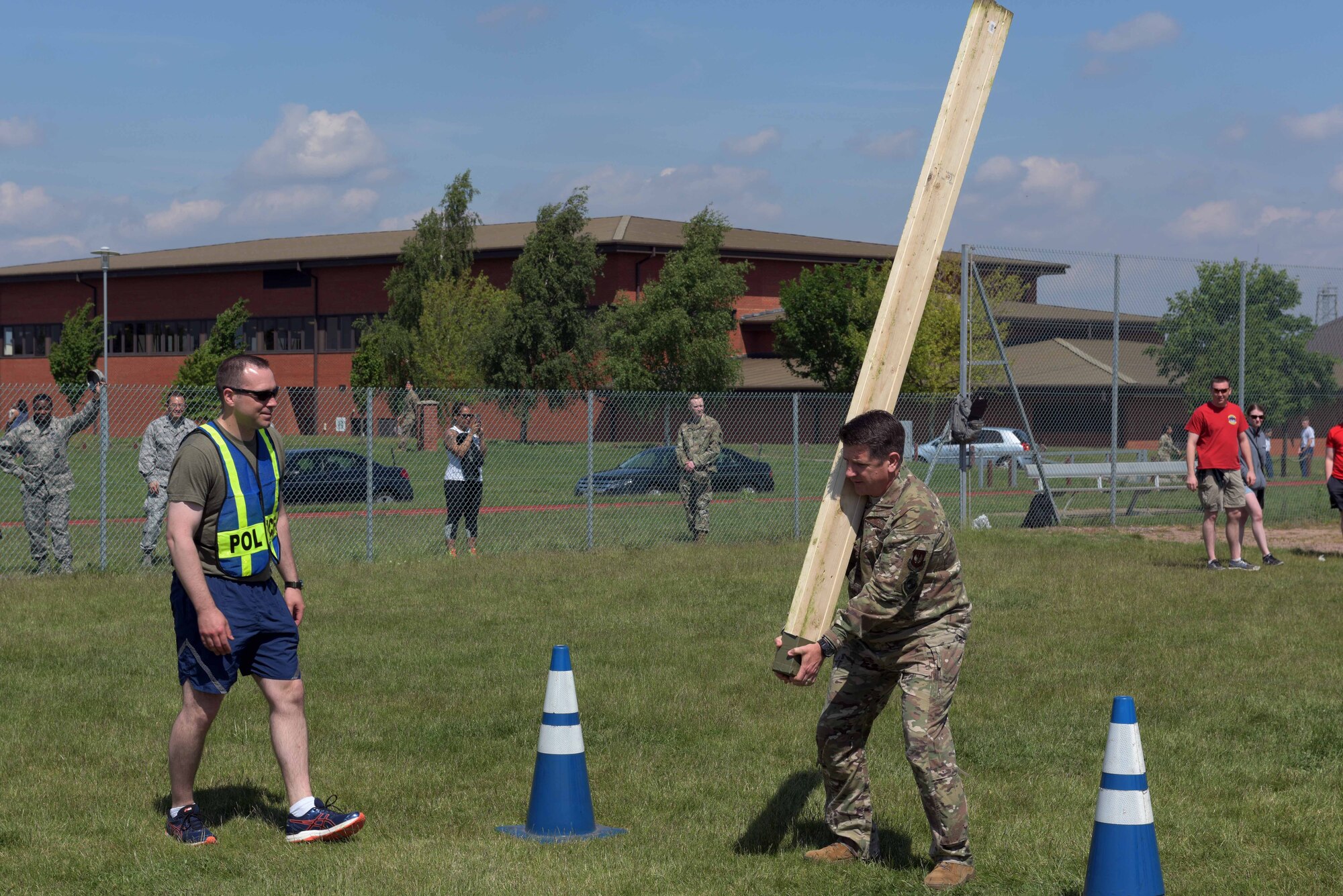 U.S. Air Force Col. Christopher Amrhein, 100th Air Refueling Wing commander, prepares to perform the caber toss during the Highland Games at RAF Mildenhall, England, May 23, 2019. Cabers are roughly trimmed tree trunks that are tossed by running forward and tossing it so that it lands on its opposite end. (U.S. Air Force photo by Senior Airman Benjamin Cooper)