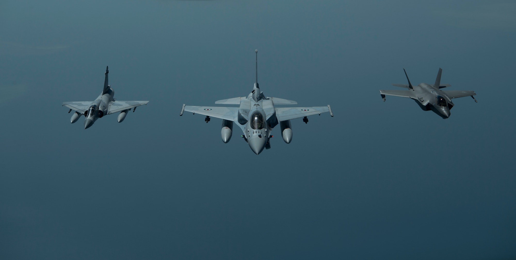 A photo of two UAE aircraft and a US aircraft flying in formation.