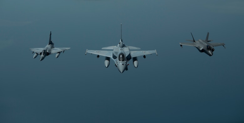 A photo of two UAE aircraft and a US aircraft flying in formation.