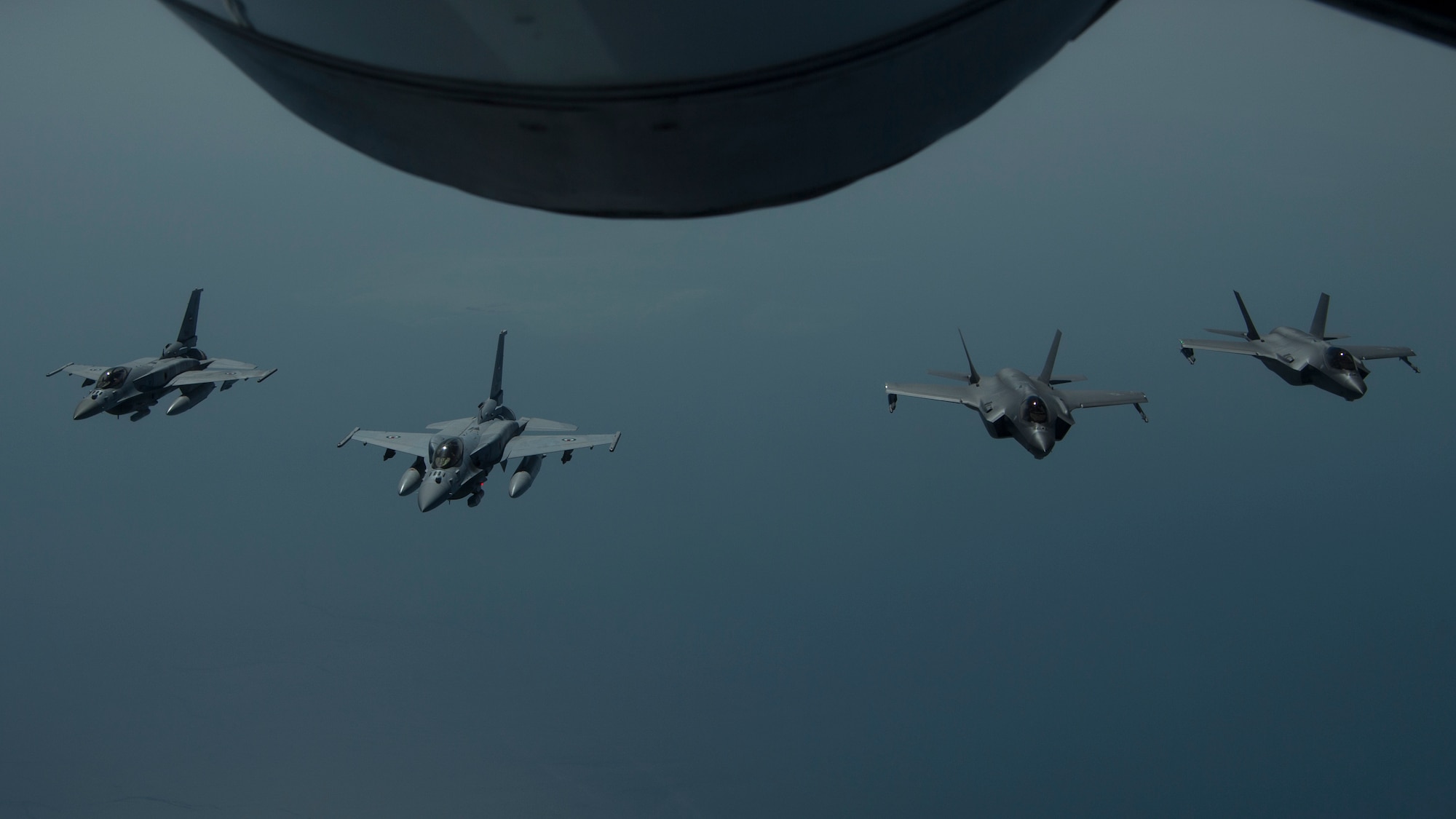 A photo of UAE and US aircraft flying together in a formation.