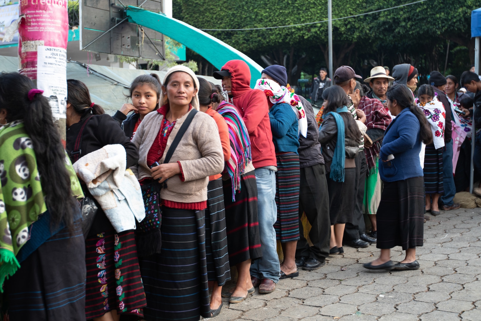 A line of people await medical treatment.