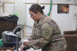 Sgt. Ruthie Huddleston, 450th Transportation Battalion, prepares a cup of coffee at Holy Joe's, a resiliency center at Camp Arifjan, Kuwait, May 20, 2019.