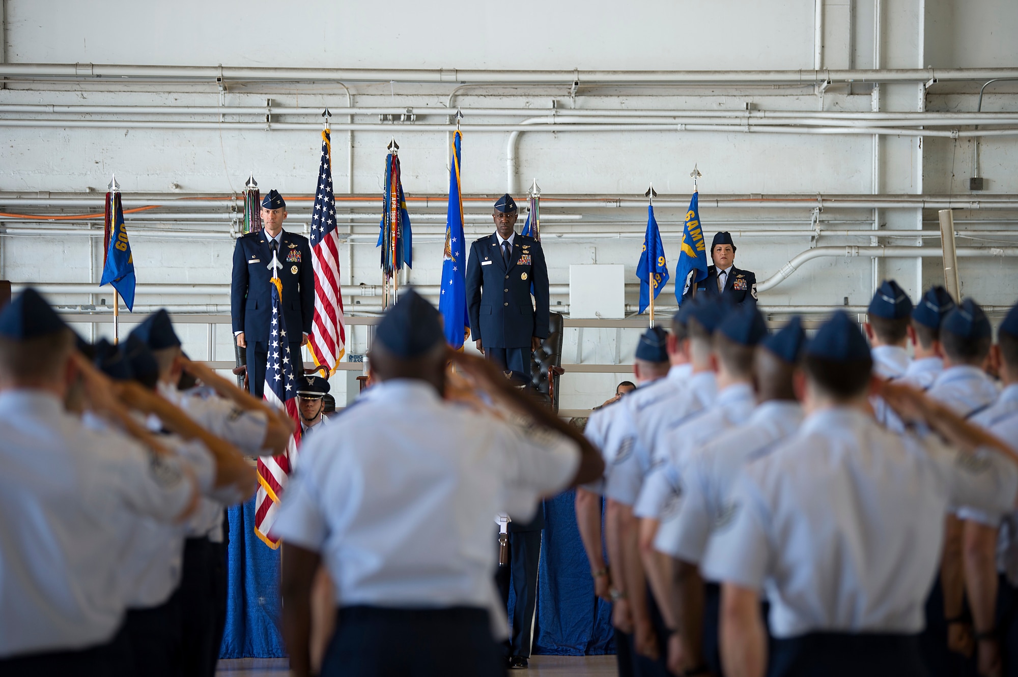Members of the 6th Operations Group salute during the presentation of the colors at an assumption of command ceremony, at MacDill Air Force Base, Fla., May 23, 2019. U.S. Air Force Col. Stephen Snelson the 6th Air Mobility Wing commander, passed the 6th OG guidon to Col. Travis Edwards, to mark the start of his tenure as the new 6th OG commander.
