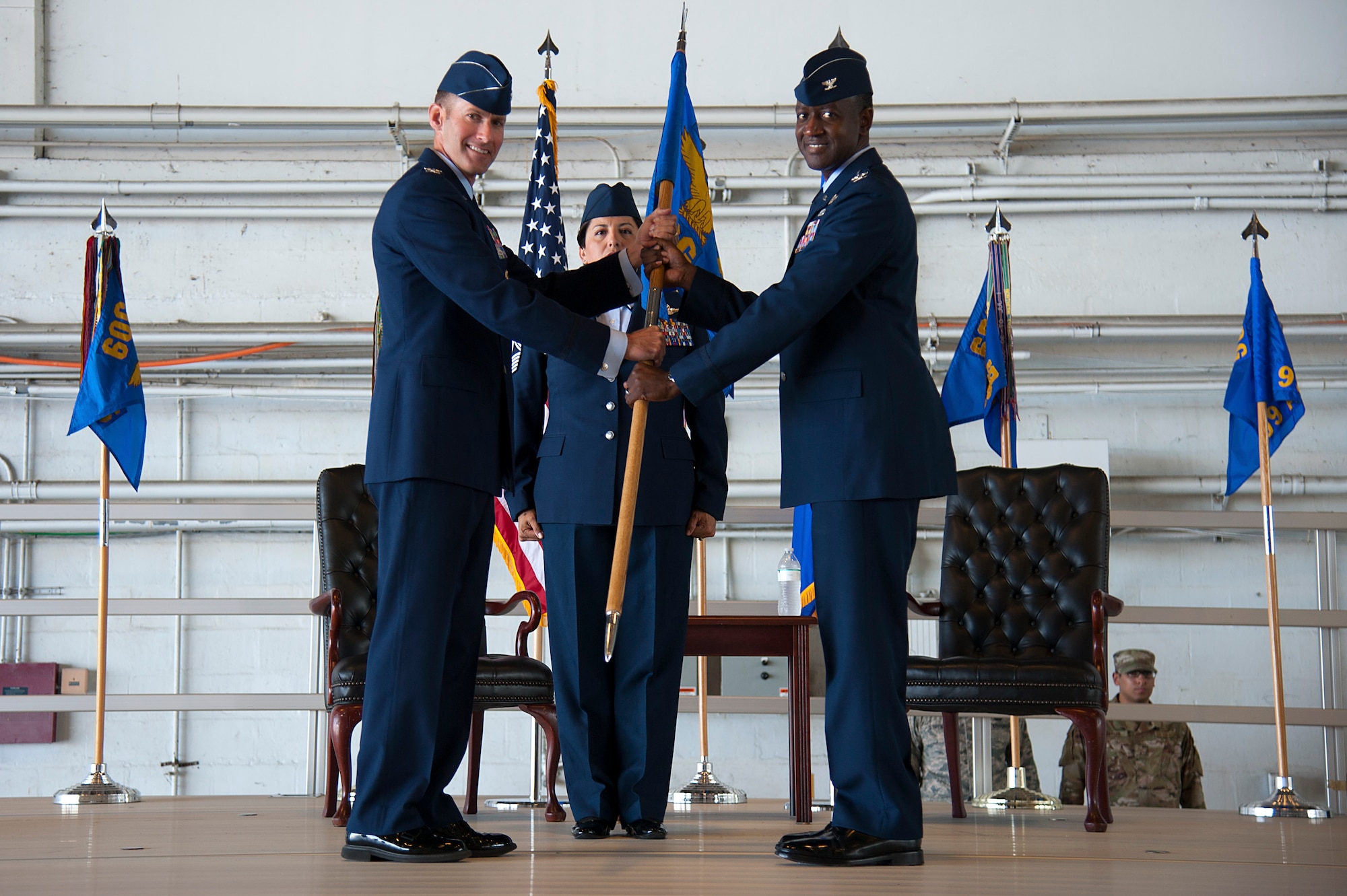 U.S. Air Force Col. Stephen Snelson, the 6th Air Mobility Wing commander, passes the 6th Operations Group guidon to incoming commander Col. Travis Edwards, during an assumption of command ceremony at MacDill Air Force Base, Fla., May 23, 2019. During Edwards’s previous assignment, he served as the U.S. Transportation Command’s Senior Liaison Officer to European Command and the North Atlantic Treaty Organization in U.S. Army Garrison Stuttgart, Germany.