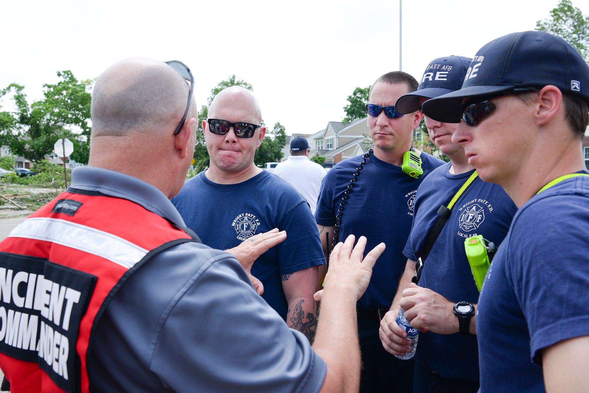 Jeffrey Kitzmiller, incident commander, briefs members of the 788th Civil Engineer Fire Department at the incident command post setup in the Prairies at Wright Field as recovery efforts begin.  Volunteers from around Wright-Patterson AFB worked alongside base emergency responders and housing residents to ensure everyone’s safety and begin the cleanup process. (U.S. Air Force photo by R.J. Oriez)