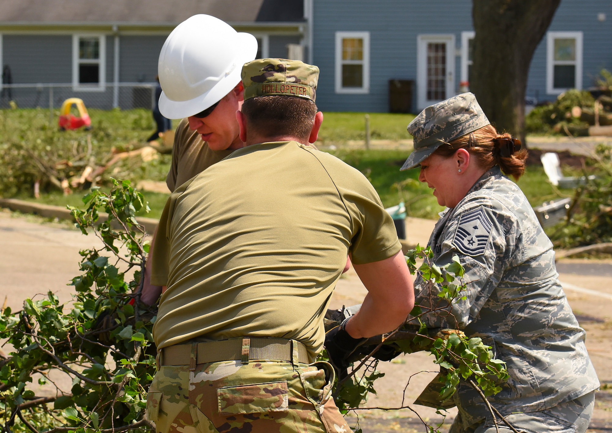 Chief Master Sgt. Jennifer Hellwig, Air Force Materiel Command first sergeant work to clear tree branches during recovery operations.  Residents worked alongside other volunteers from around Wright-Patterson AFB and base emergency responders to ensure everyone’s safety and begin the cleanup process. (U.S. Air Force photo by R.J. Oriez)