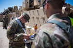 Idaho Army National Guard 1st Lt. Jermey  Raush and 1st Lt. Tyler June, engineer officers with the 116th Brigade Engineer  Battalion, 116th Cavalry Brigade Combat Team, make a plan to get their platoon of Bradley Fighting Vehicles' Multiple Integrated Laser Engagement System Equipment installed May 25, 2019, at the National training Center at  Fort Irwin, Calif. The 116th Cavalry Brigade Combat Team is training at the NTC May 24 to June 20 to prepare for its wartime missions.