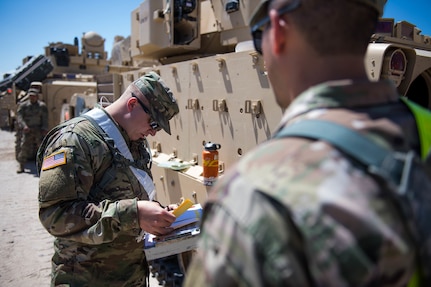 Idaho Army National Guard 1st Lt. Jermey  Raush and 1st Lt. Tyler June, engineer officers with the 116th Brigade Engineer  Battalion, 116th Cavalry Brigade Combat Team, make a plan to get their platoon of Bradley Fighting Vehicles' Multiple Integrated Laser Engagement System Equipment installed May 25, 2019, at the National training Center at  Fort Irwin, Calif. The 116th Cavalry Brigade Combat Team is training at the NTC May 24 to June 20 to prepare for its wartime missions.