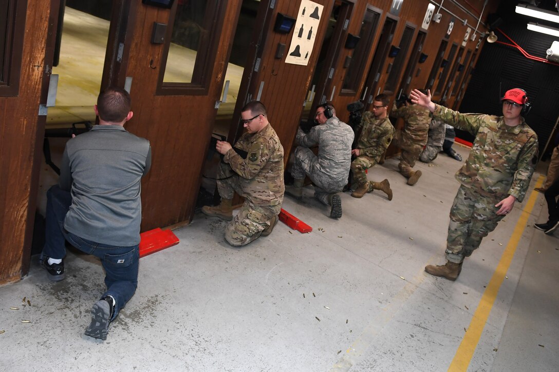 A Combat Arms Training and Maintenance instructor with the 319th Security Forces Squadron signals that his side of competitors is prepared to begin shooting May 16, 2019, on Grand Forks Air Force Base, North Dakota. The shooting competition took place during National Police Week, which was celebrated with a variety of events and competitions by airmen and families on base. (U.S. Air Force photo by Senior Airman Elora J. Martinez)