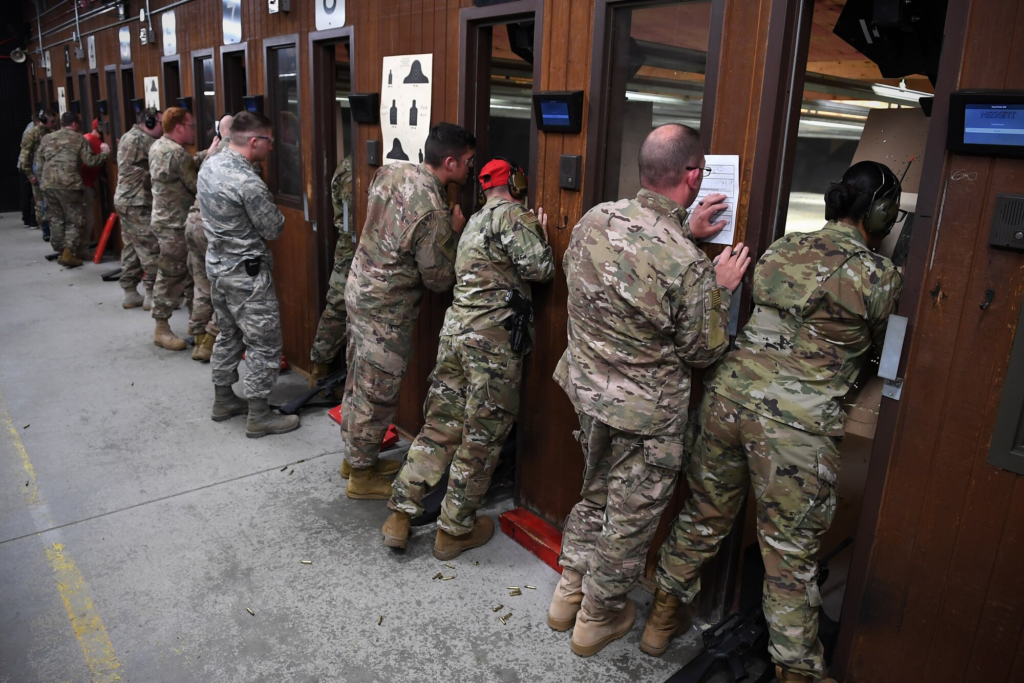 Competitors examine their targets after firing M16A2 rifles May 16, 2019, as part of a shooting competition on Grand Forks Air Force Base, North Dakota. The competition was one of several events the 319th Security Forces Squadron hosted in honor of National Police Week May 13-17. (U.S. Air Force photo by Senior Airman Elora J. Martinez)