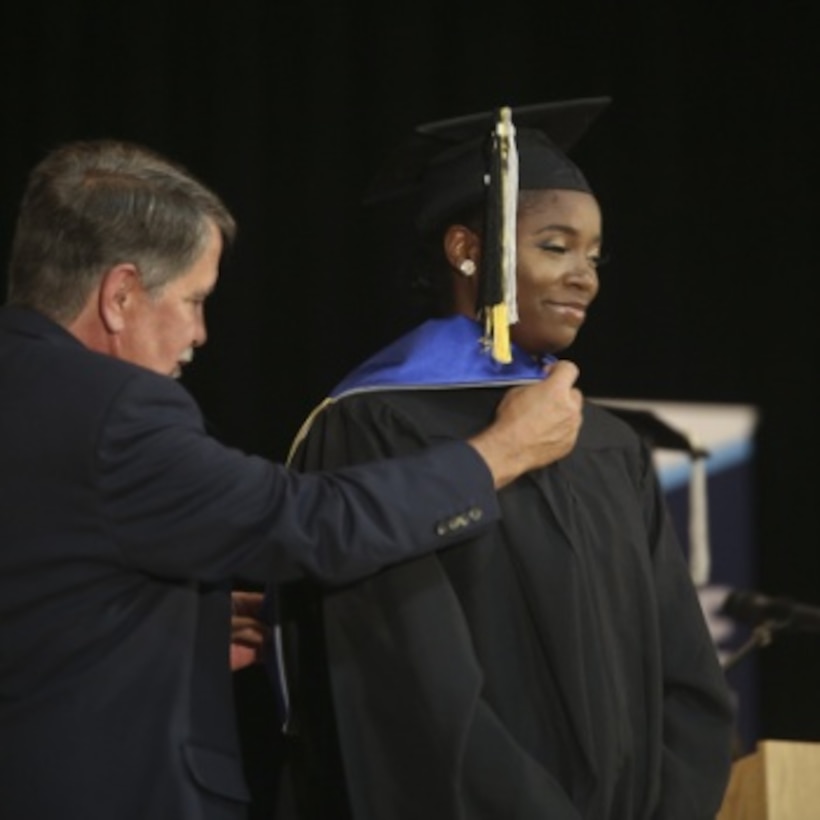 Cpl. Kylaine Rogers gets a sash placed on her by Tom Nance at her graduation aboard Marine Corps Recruit Depot Parris Island, May 17. Nance is the assistant campus director for Embry-Riddle University's Beaufort Campus.