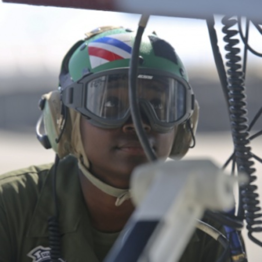 Cpl. Kylaine Rogers examines the electronic equipment of a F-18 on the flightline of Marine Corps Air Station Beaufort, May 23. Rogers is an avionic technician with VMFA-115 and graduated with her Master's degree from Embry-Riddle University in Aeronautics.