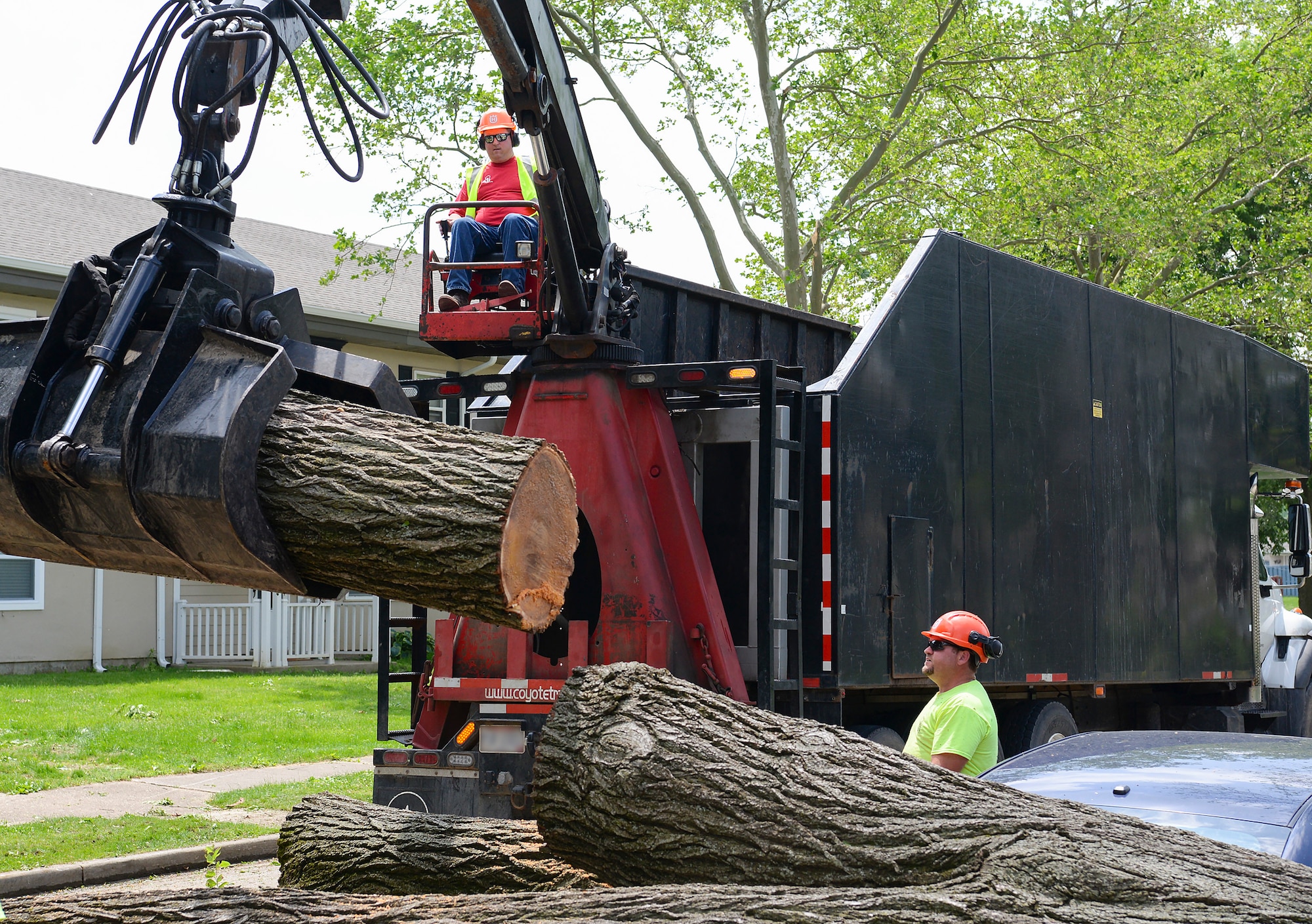 Contractors use heavy equipment to remove larges logs during the recovery operations at Wright-Patterson AFB.  Volunteers from around Wright-Patterson AFB worked alongside base emergency responders and housing residents to ensure everyone’s safety and begin the cleanup process.  (U.S. Air Force photo by R.J. Oriez)