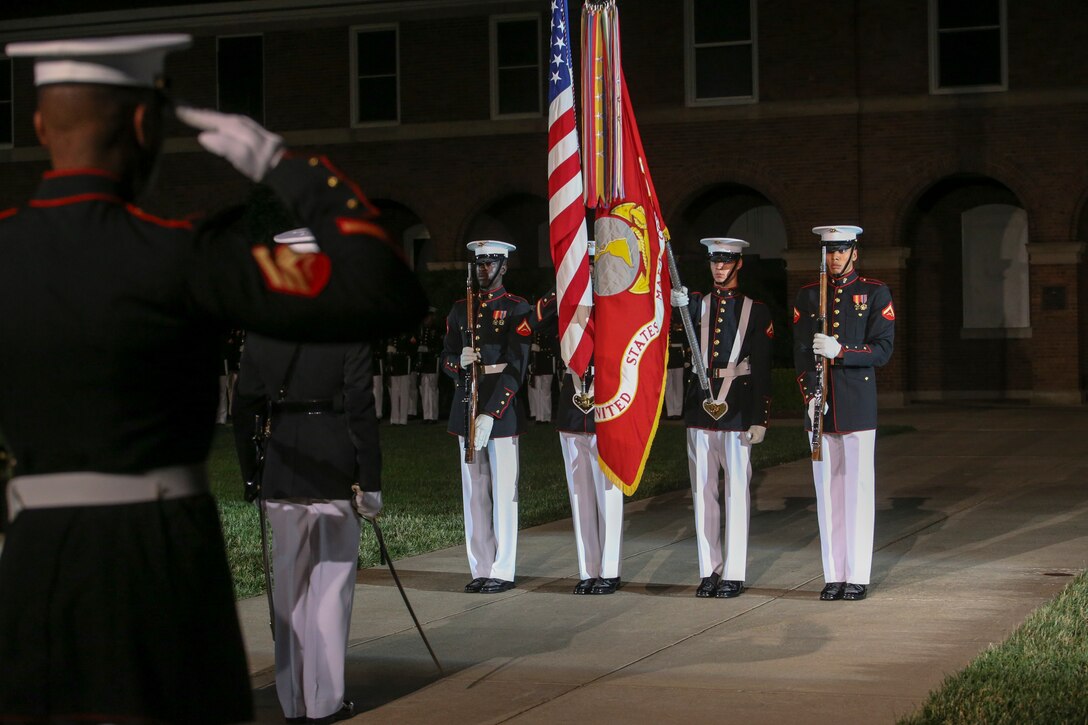 Marines with the U.S. Marine Corps Color Guard present the National Colors during a Friday Evening Parade at Marine Barracks Washington, D.C., May 5, 2019. The hosting official for the evening was the 19th Chairman of the Joint Chiefs of Staff Gen. Joseph F. Dunford, and the guest of honor was Ms. Bonnie Carroll, the president and founder of the Tragedy Assistance Program for Survivors and 2015 Presidential Medal of Freedom recipient. (U.S. Marine Corps photo by Pfc. Allen Sanders)