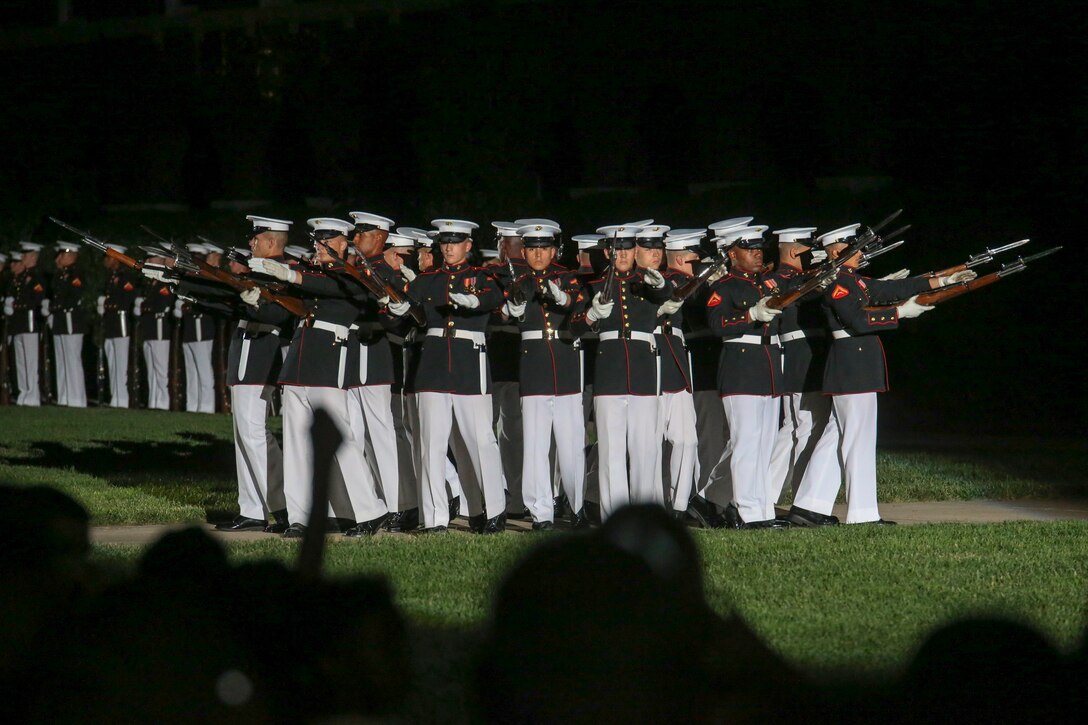 Marines with the U.S. Marine Corps Silent Drill Platoon execute their “bursting bomb” sequence during a Friday Evening Parade at Marine Barracks Washington, D.C., May 5, 2019. The hosting official for the evening was the 19th Chairman of the Joint Chiefs of Staff Gen. Joseph F. Dunford, and the guest of honor was Ms. Bonnie Carroll, the president and founder of the Tragedy Assistance Program for Survivors and 2015 Presidential Medal of Freedom recipient. (U.S. Marine Corps photo by Pfc. Allen Sanders)