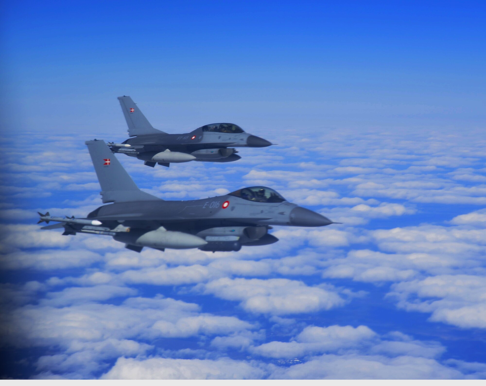 Royal Danish Air Force F-16C and F-16D exit refueling from the KC-135 Stratotanker, McGuire Air Force Base N.J., over Finland, May 24, 2019. The aircraft are supporting Arctic Challenge Exercise 19, a Nordic aviation exercise intended to provide scenario-based training to prepare partner forces for enemy defensive systems. (U.S. Air National Guard photo by Staff Sgt. Kenneth Shaner Brown)