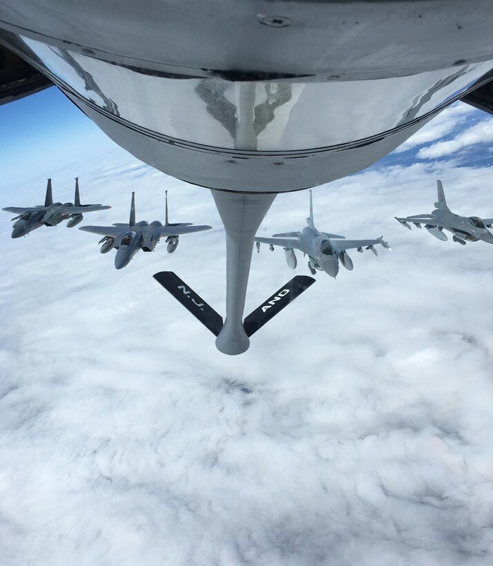 U.S. Air Force F-15 Eagles from 104th Fighter Wing, Barnes Air National Guard Base, Mass., form up next to Royal Danish Air Force F-16 Falcons behind a KC-135 Stratotanker from Joint Base McGuire-Dix-Lakehurst, N.J., after receiving fuel over Sweden, May 24, 2019.  The aircraft are supporting Arctic Challenge Exercise 19, a Nordic aviation exercise intended to provide scenario-based training to prepare partner forces for enemy defensive systems. (U.S. Air Force photo by Staff Sgt. Kenneth Shaner Brown)