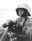 A female Coast Guardsman on board a cutter.