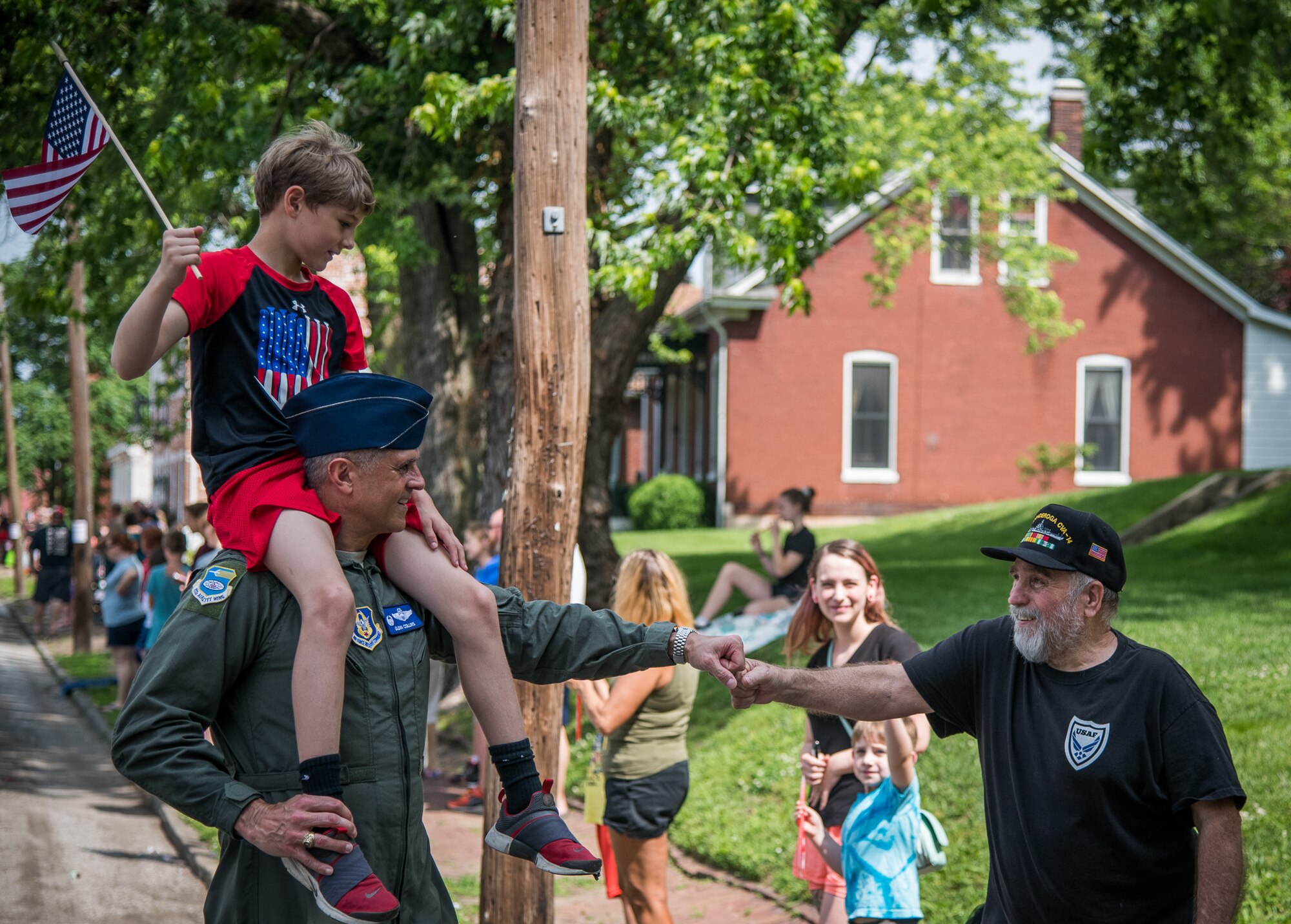 Col. Glenn Collins, commander, 932nd Airlift Wing, with his son perched on his shoulders, gives a fist bump of appreciation to an Air Force veteran during the Belleville Memorial Day Parade, May 27, 2019, Belleville, Illinois. “What an absolute privilege to be able to participate in the Belleville Community Parade where we honor those who sacrificed so much for each of us, while connecting with our community and reaffirming bonds with former service members,” said Collins. (U.S. Air Force photo by Christopher Parr)