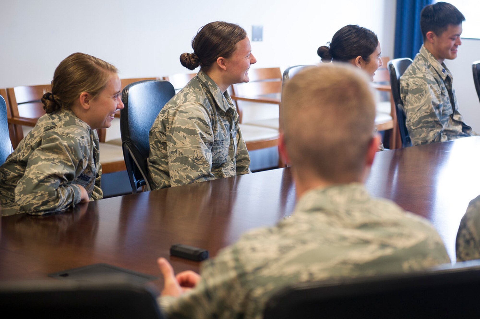 ROTC Cadets from universities across the country laugh during a discussion with Maj. Gen. James A. Jacobson, Air Force District of Washington commander, at Joint Base Andrews, Md., May 22, 2019. The cadets had a chance to sit down with Jacobson during a stop while touring the Washington area. (U.S. Air Force photo by Master Sgt. Michael B. Keller)
