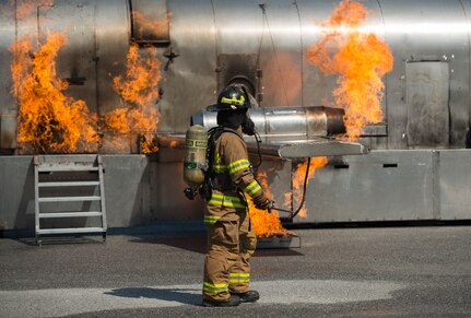 Senior Airman Nathan Warczok, a firefighter assigned to the 628th Civil Engineer Squadron, walks in front of a mobile aircraft fire training unit May 27, 2019, at Joint Base Charleston, S.C.