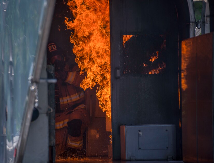 A firefighter assigned to the 628th Civil Engineer Squadron puts out a fire in a mobile aircraft fire training unit May 27, 2019, at Joint Base Charleston, S.C.