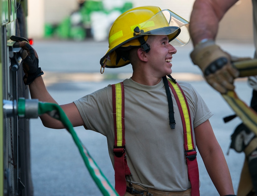 Airman 1st Class Melvin Frick, a firefighter assigned to the 628th Civil Engineer Squadron stands by a fire truck hose May 27, 2019, at Joint Base Charleston, S.C.