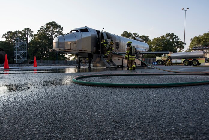 Firefighters assigned to the 628th Civil Engineer Squadron back out of a mobile aircraft fire training unit May 27, 2019, at Joint Base Charleston, S.C.