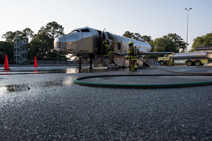 Firefighters assigned to the 628th Civil Engineer Squadron back out of a mobile aircraft fire training unit May 27, 2019, at Joint Base Charleston, S.C.