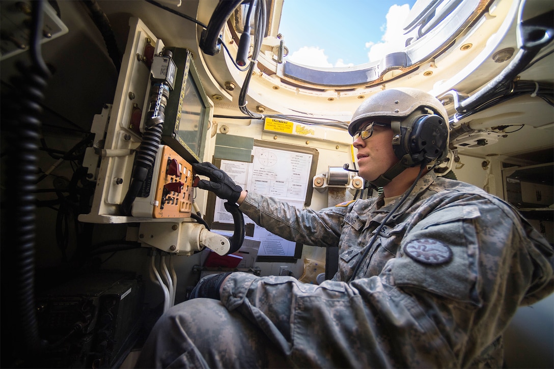 A soldier operates a tank.