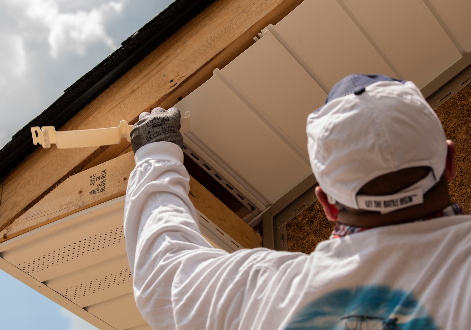U.S. Air Force 1st Lt. Justin A. Reese, 20th Aircraft Maintenance Squadron sortie generation flight commander, checks if house siding needs to be resized during a Habitat for Humanity event in Sumter, S.C., May 4, 2019.
