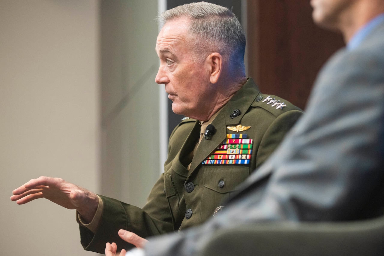 Marine general gestures while talking.